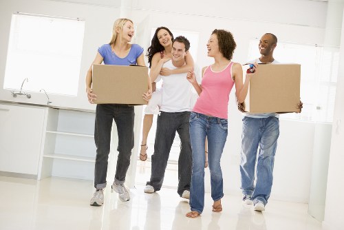 Furniture removals team handling large household items in Roehampton