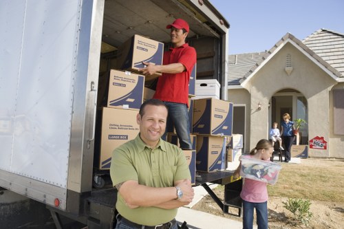 Professional movers handling furniture access in a Roehampton flat