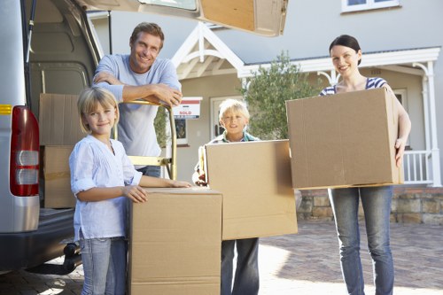 Loading furniture into a van on a Roehampton residential street