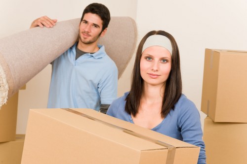 Professional furniture movers working in a Roehampton flat with stairs