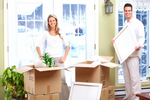 Packed boxes and furniture ready for collection by van in Roehampton