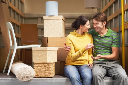 Loading furniture and boxes into a moving van in Roehampton